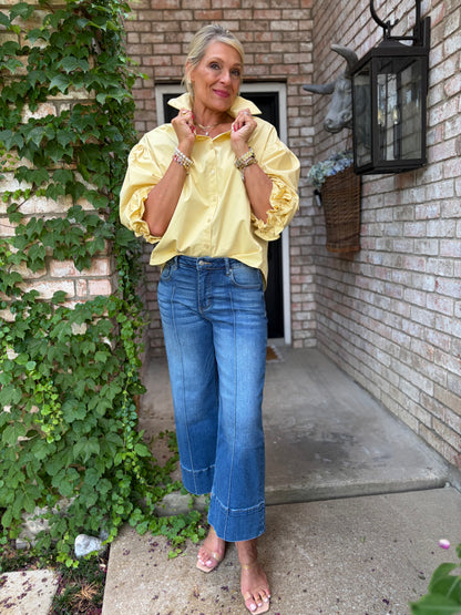 button up butter colored cotton blouse with half sleeve and ruffle detail with blue denim