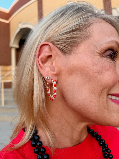 gold hoop earring adorned with red and white beads