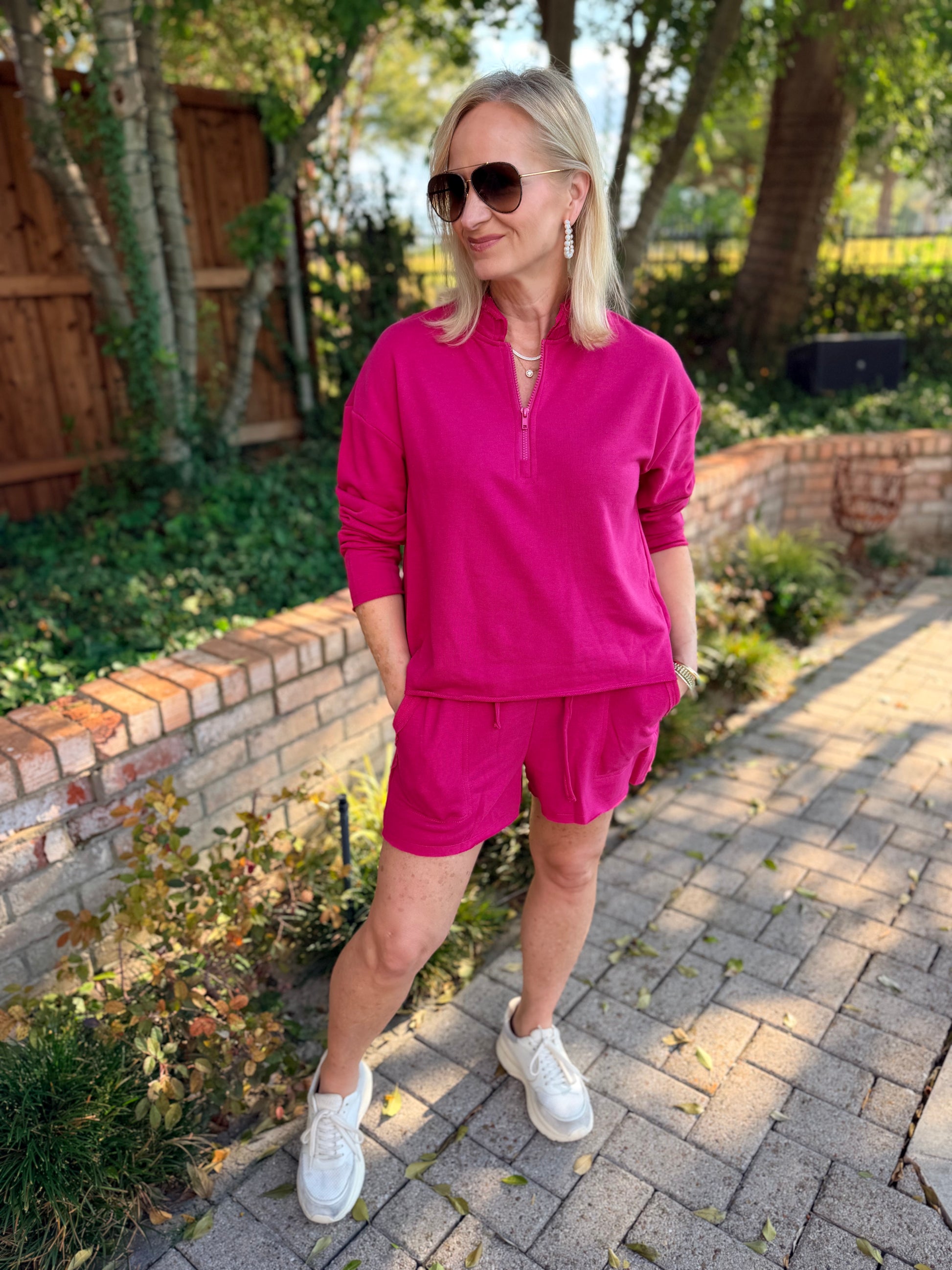 A soft cotton raspberry pink comfy shirt set.  The top is long sleeve, light weight with zipper front 1/2 down.  Elastic waist matching shorts mid length 