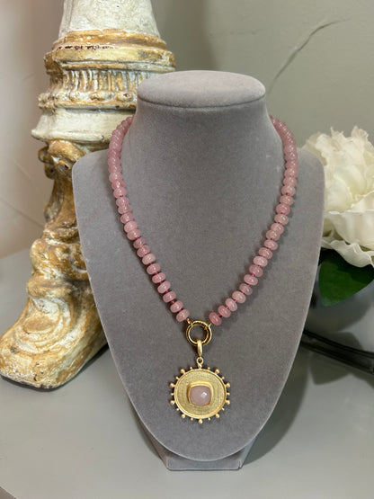 pink jade beaded necklace strand with brushed gold medallion with pink faceted center stone