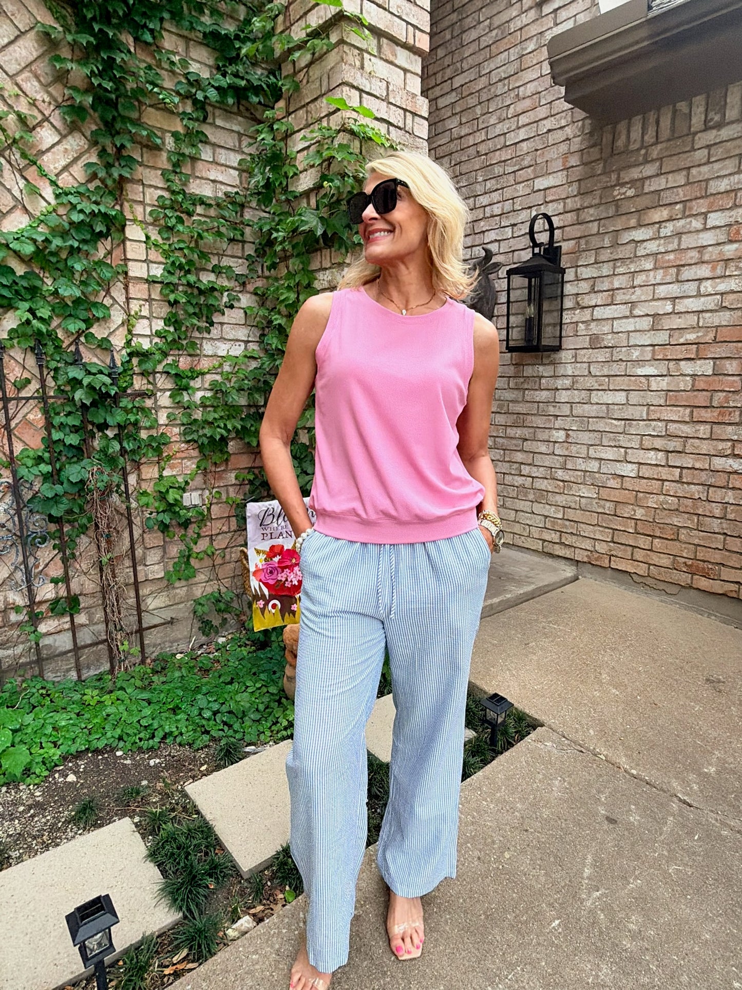 light pink sleeveless top with a white and blue striped pant