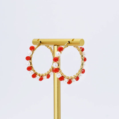 Gold hoop earrings with dangling red and white beads