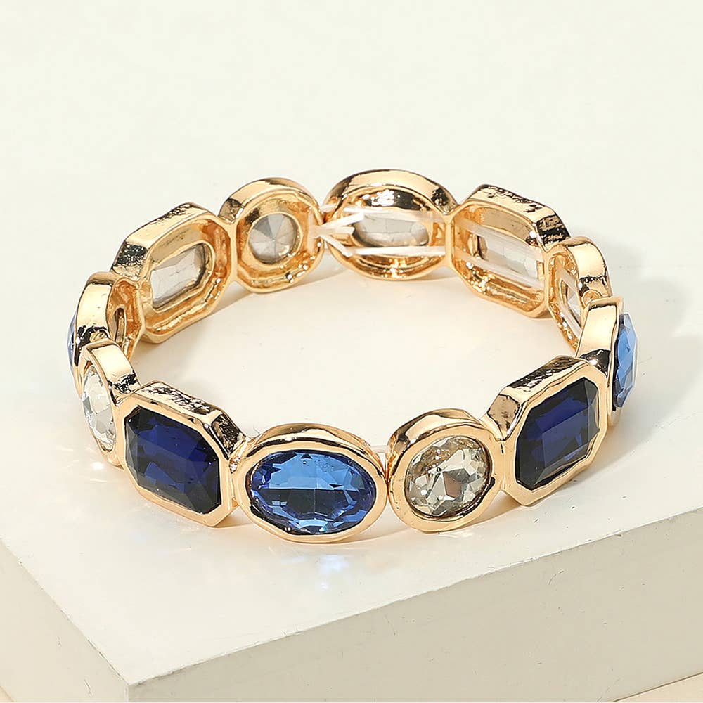 Gold stretch bracelet with blue and clear gemstones 