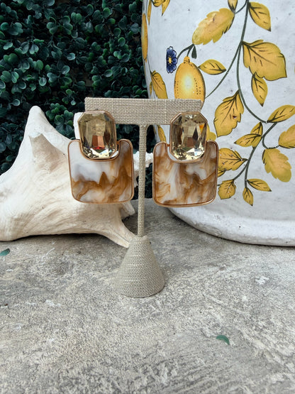 brown swirl earrings with a champagne color stone 