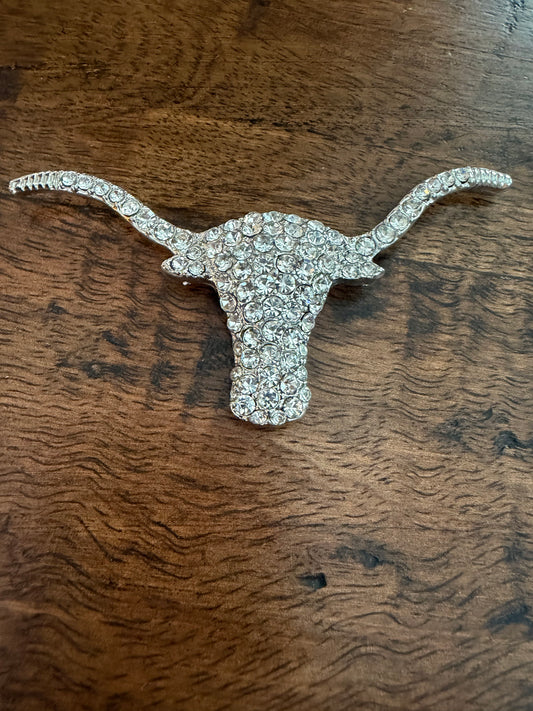 A rhinestone-covered longhorn steer head brooch in a silver-tone metal