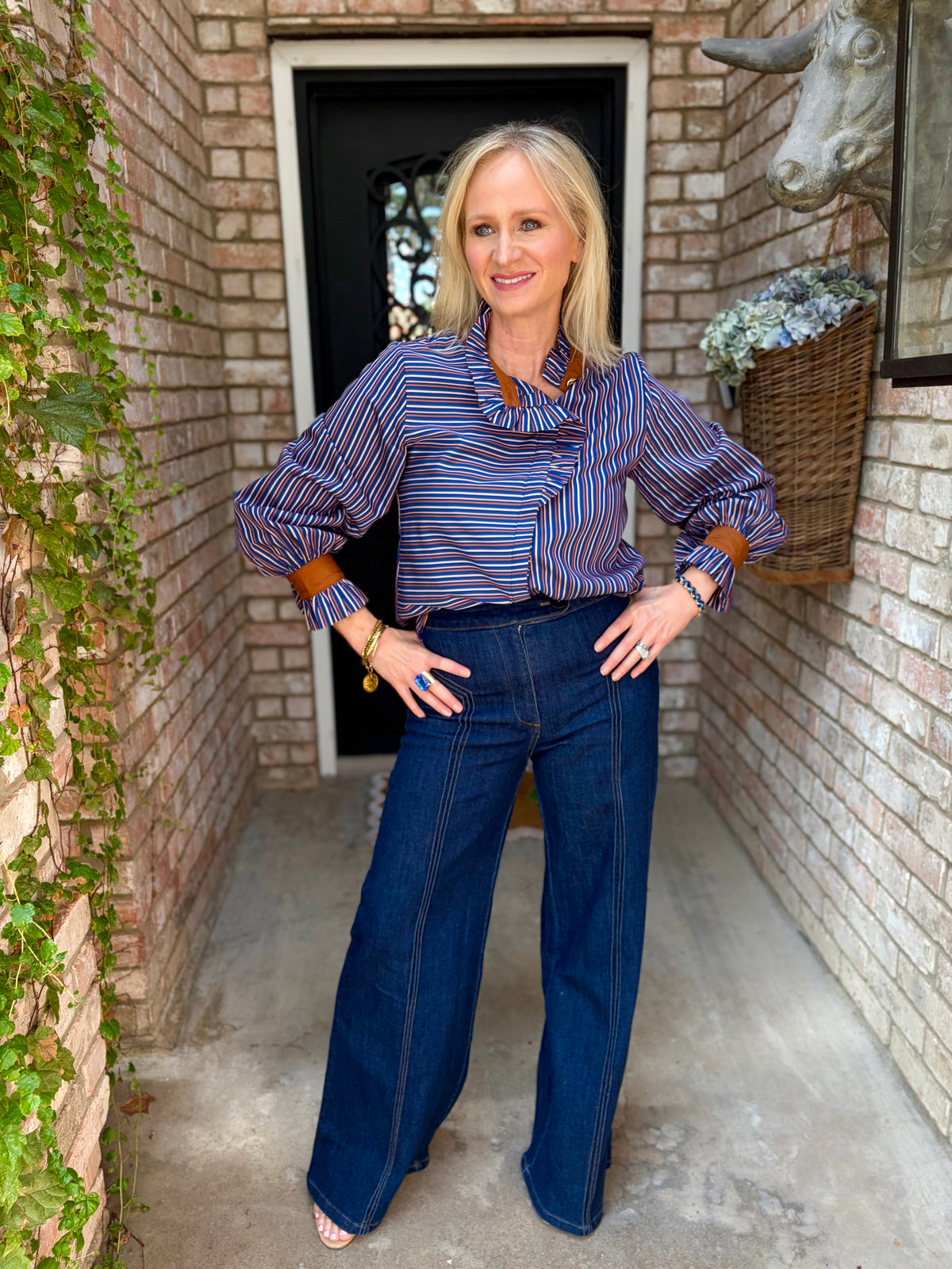 blue, toffee and light peach striped long-sleeve blouse with brown cuffs. Ruffle neck, button down