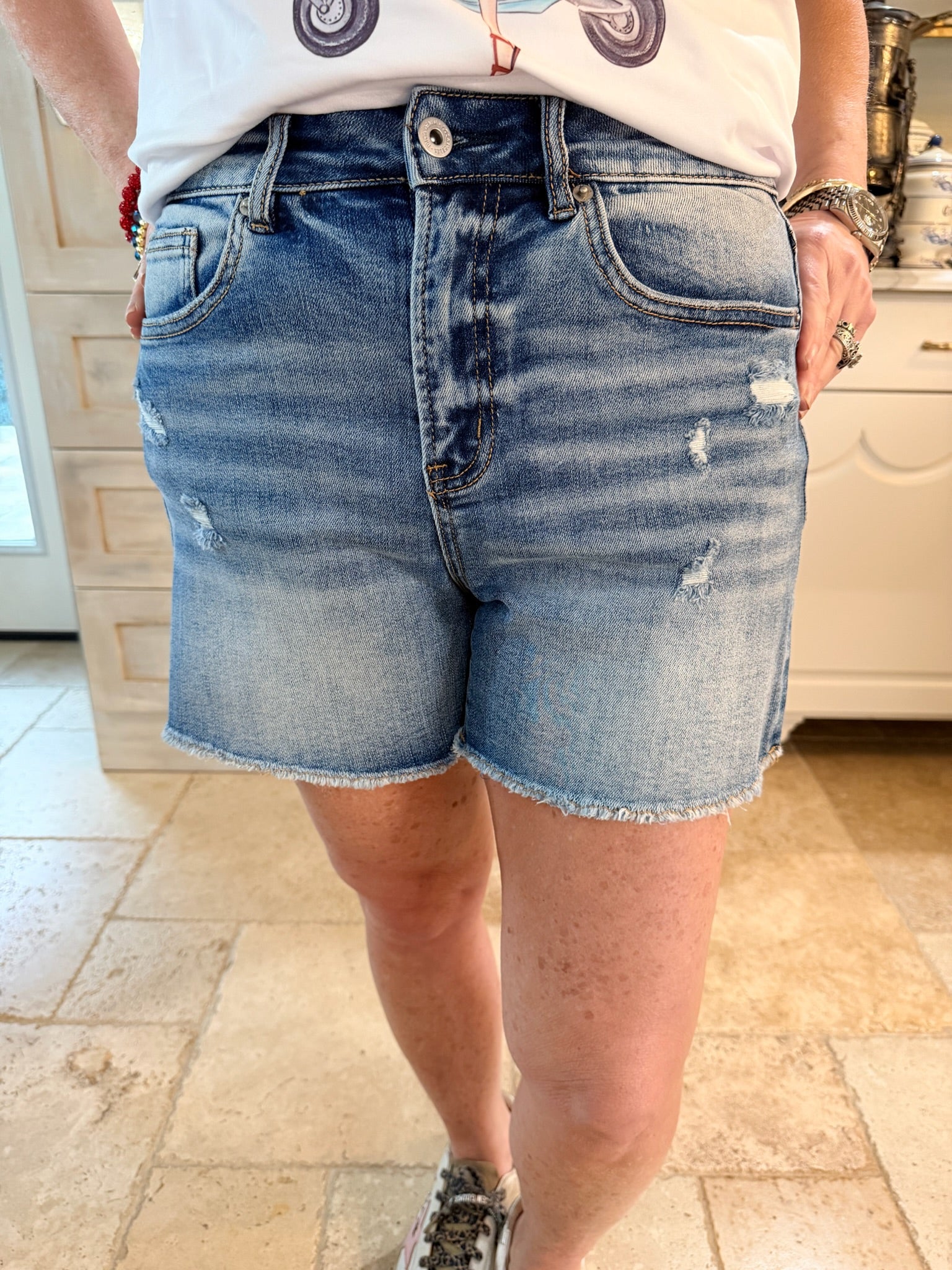 Person wearing mica denim shorts with frayed ends
