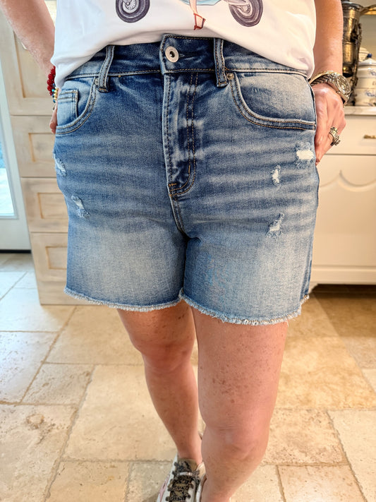 Person wearing mica denim shorts with frayed ends
