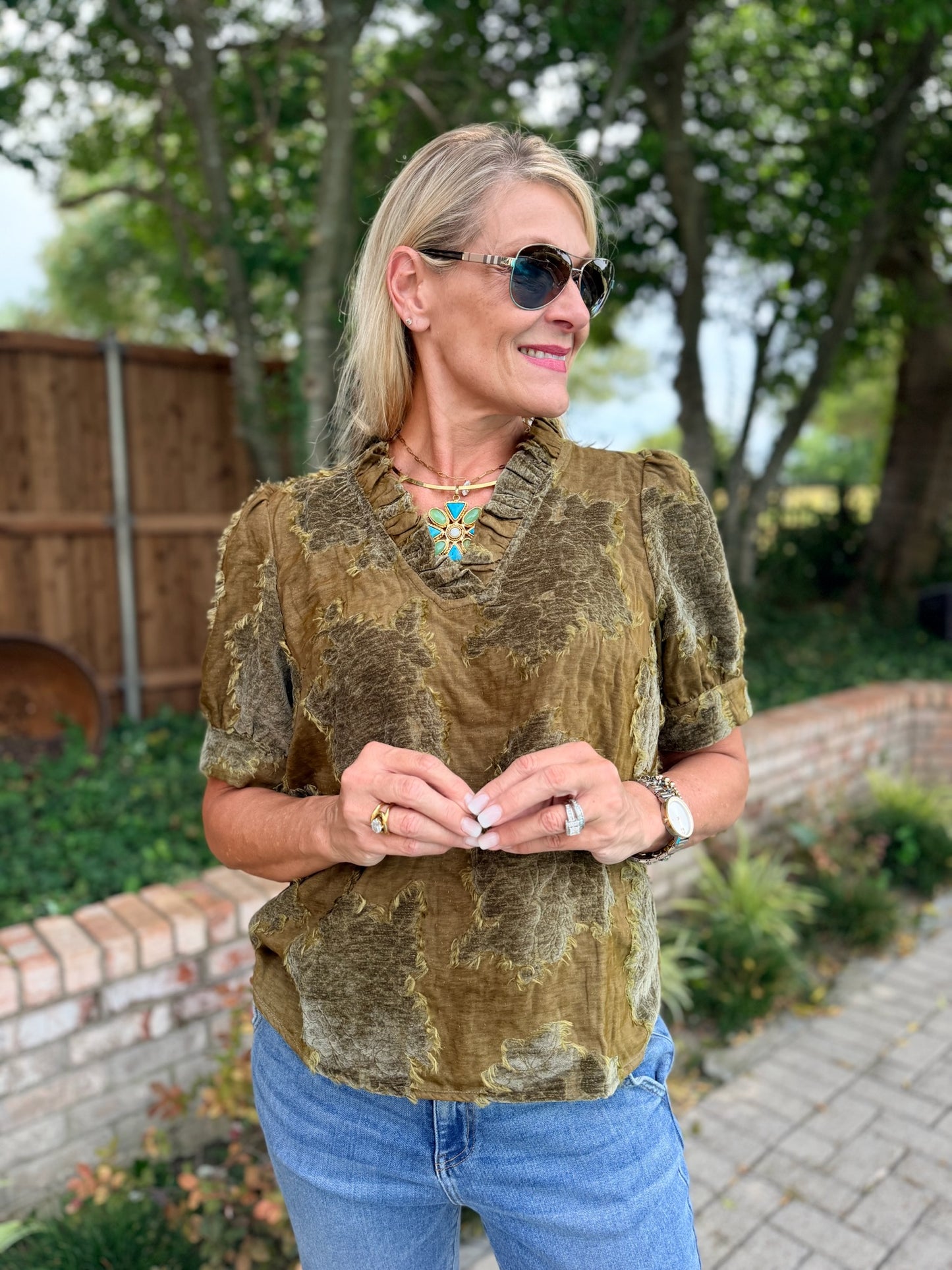 a woman wearing a v neck soft, green on green damask short sleeve blouse