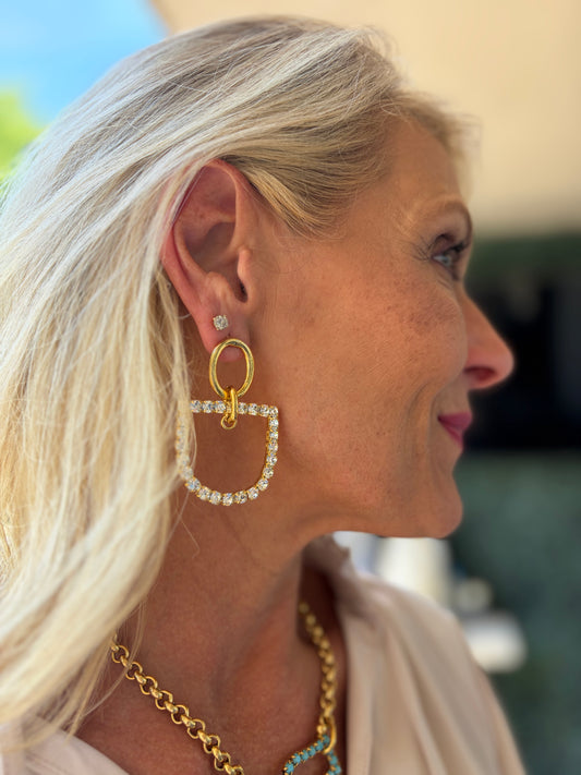 a stunning horsebit shaped earring in 22k gold plating dangle with bit adorned with rhinestones.