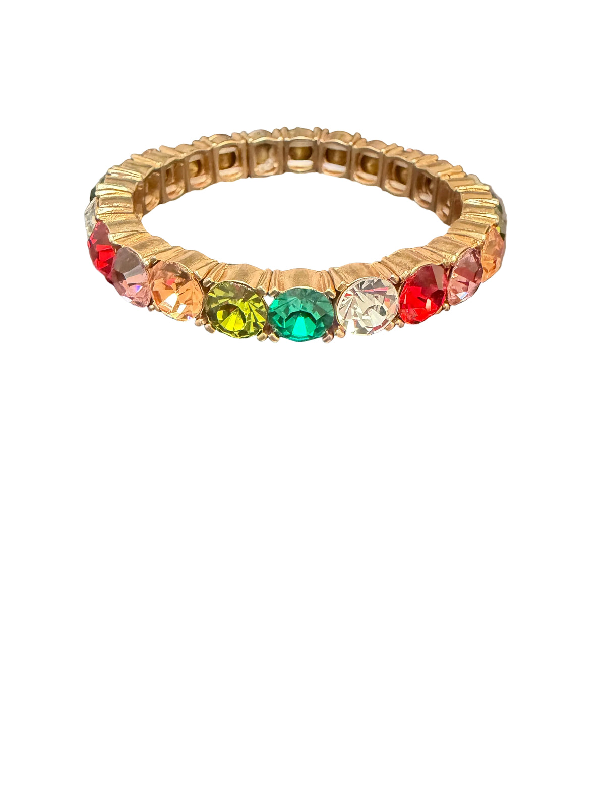 A gold-tone stretch bracelet featuring a row of colorful faceted rhinestones in red, orange, yellow-green, teal, and clear, resting on a dark, wet surface.