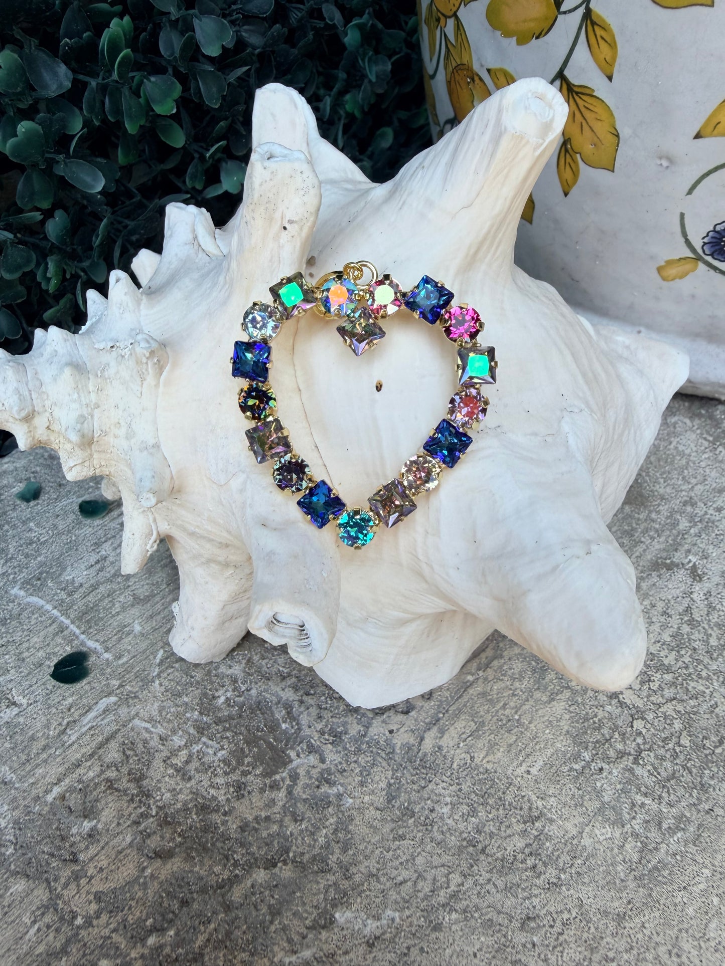 heart shaped pendant with round and square crystals in blue tones