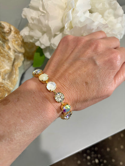 Gold link water resistant  bracelet with netural palatte of white, crystal and cream opaque colors gemstones. 