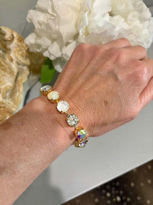 Gold link water resistant  bracelet with netural palatte of white, crystal and cream opaque colors gemstones. 
