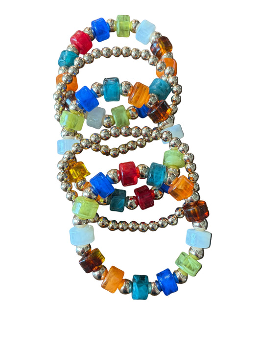 mulitcolor cylinder shaped acrylic beads and gold round beads as spacers. stack of 5 bracelets to the set
