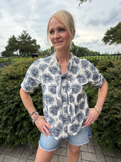 linen and cotton short sleeve blouse with button down and tie collar with light denim and dark denim blue flower design