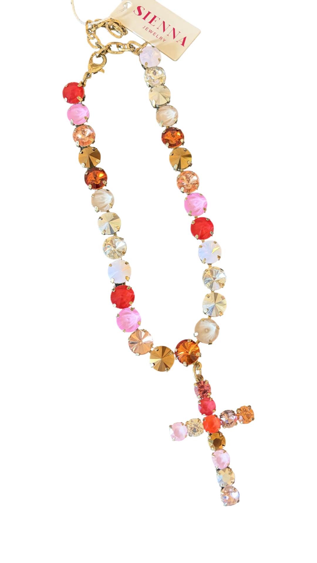 colorful crystal necklace with red, pink, crystal and topaz colors in antique gold brass and matching cross pendant hanging in middle sienna by tova