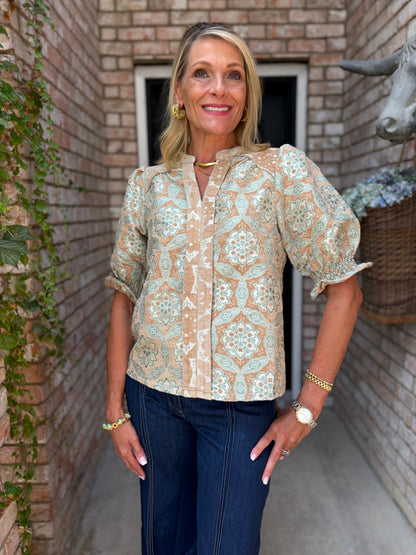 champagne and turquoise patterned puff-sleeve blouse. V neck, short sleeve