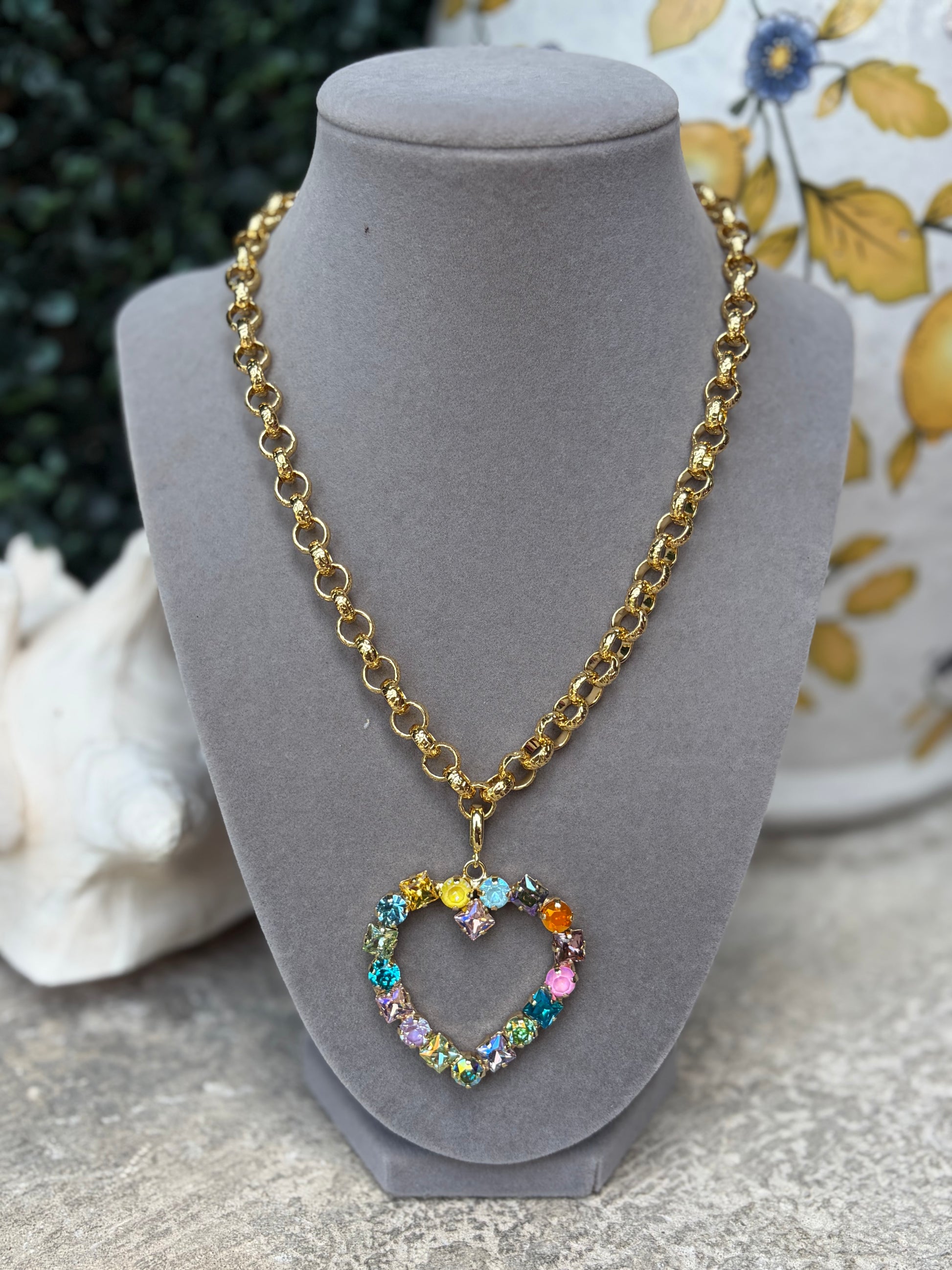 heart shaped crystal rhinestone pendant charm in soft pastel colors on a gold necklace