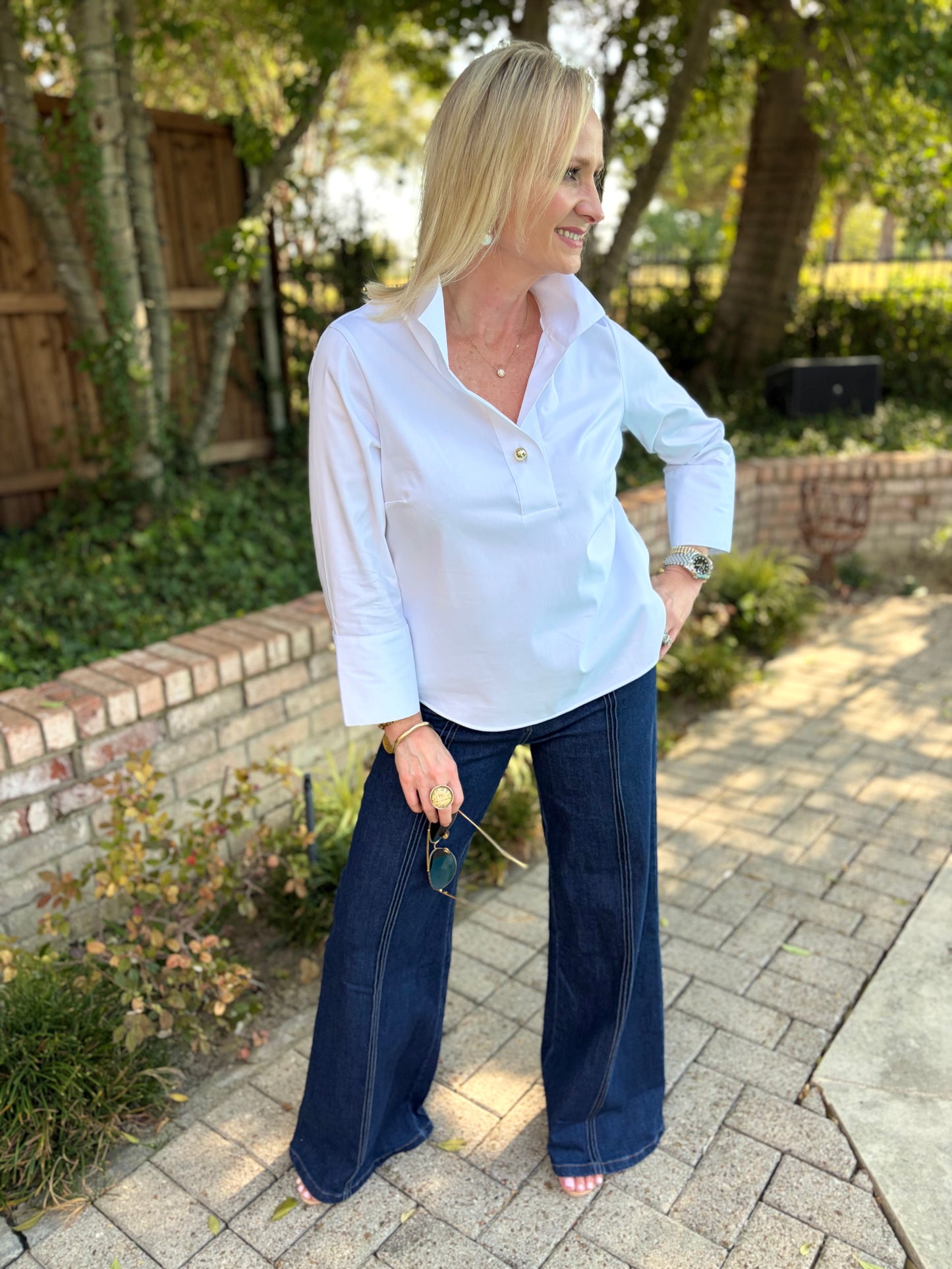 white v neck poplin blouse, long sleeve. Gold button accent on front, collar. pullover