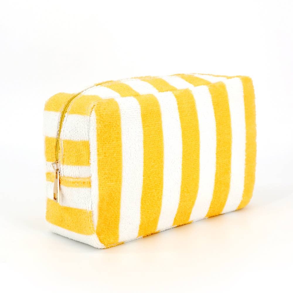 Yellow and white striped toiletry bag on a white background