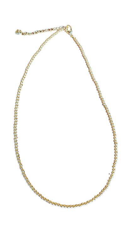 A delicate gold chain necklace with a small lobster clasp and extender chain, displayed on a solid white background.