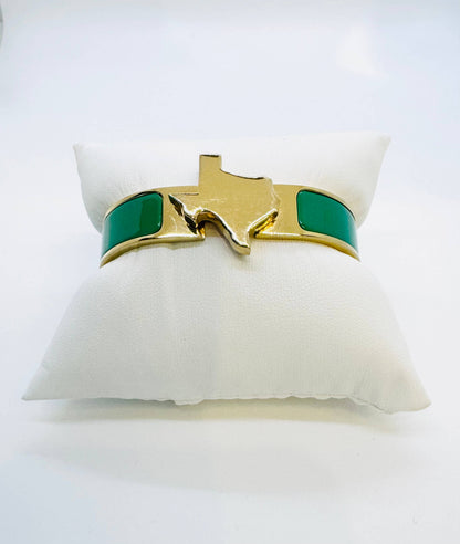 Gold and green enamel bangle bracelet with the shape of texas in gold in center and it is raised. 