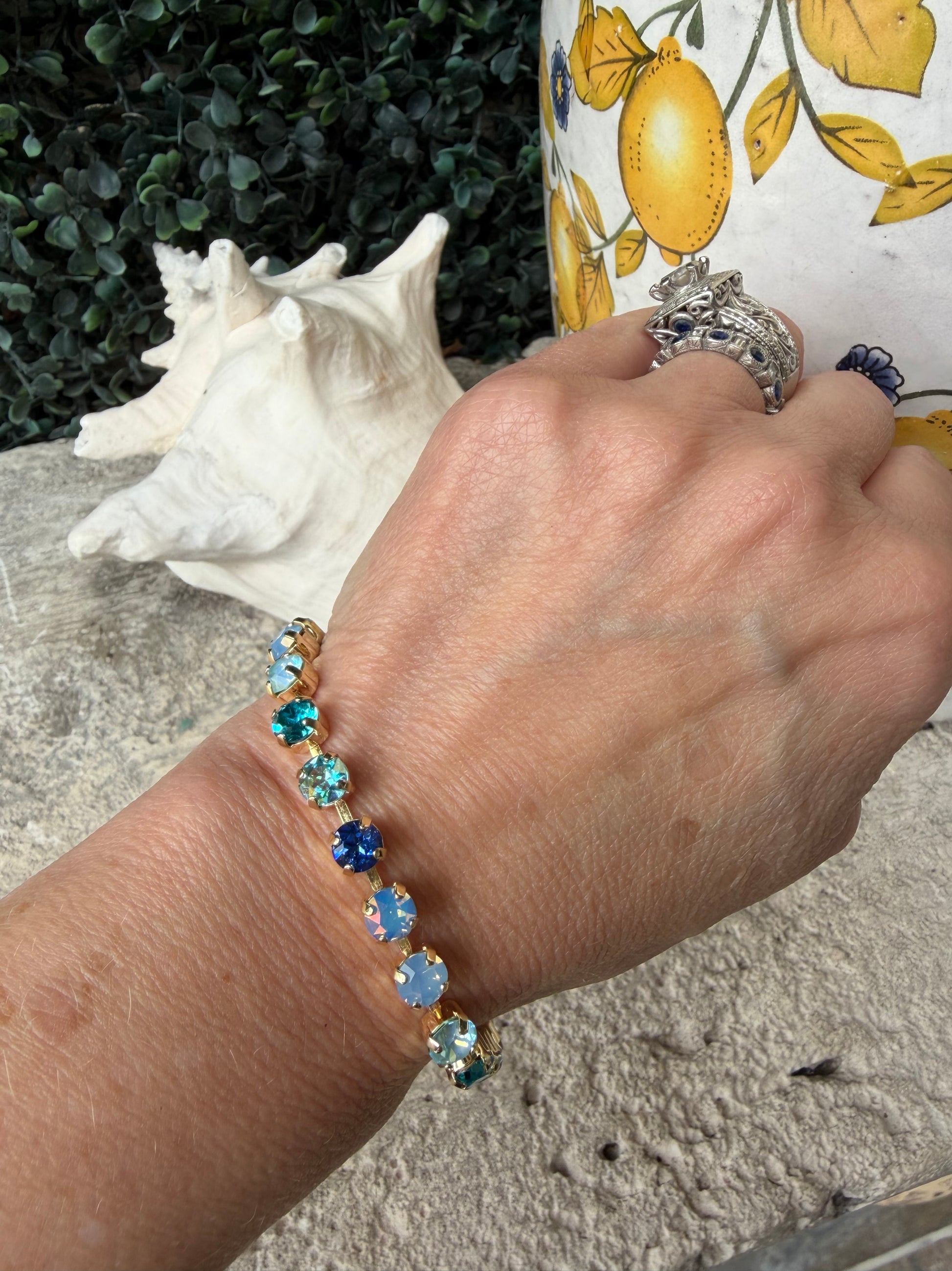 stunning crystal link bracelet that is set in gold in blue tones