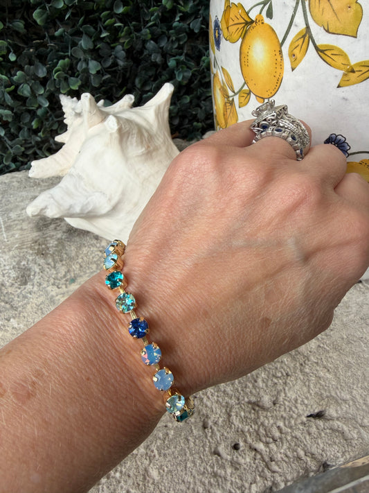 stunning crystal link bracelet that is set in gold in blue tones