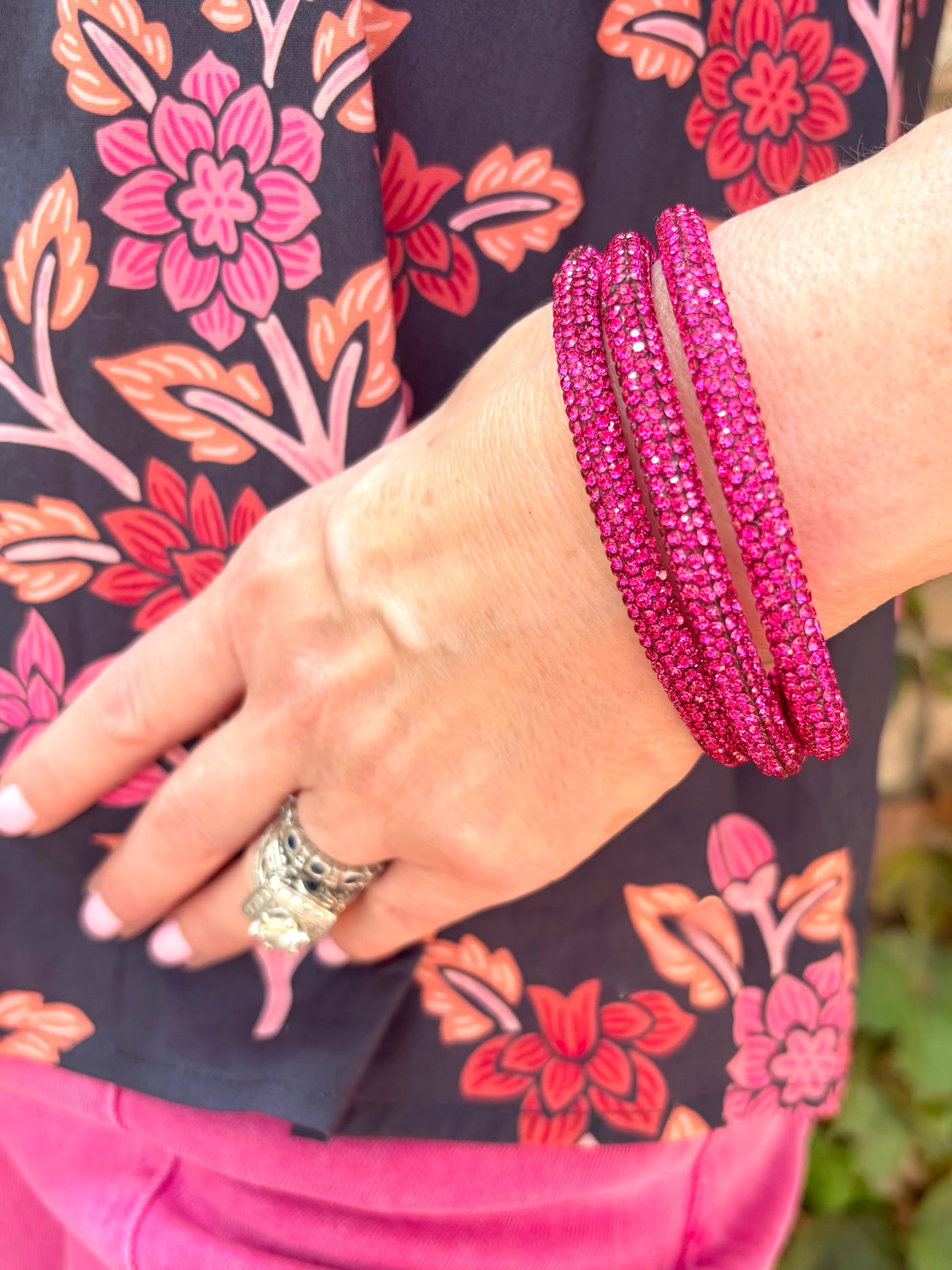 a 3 stack bracelet bangle set of bright pink pave rhinestones. 
