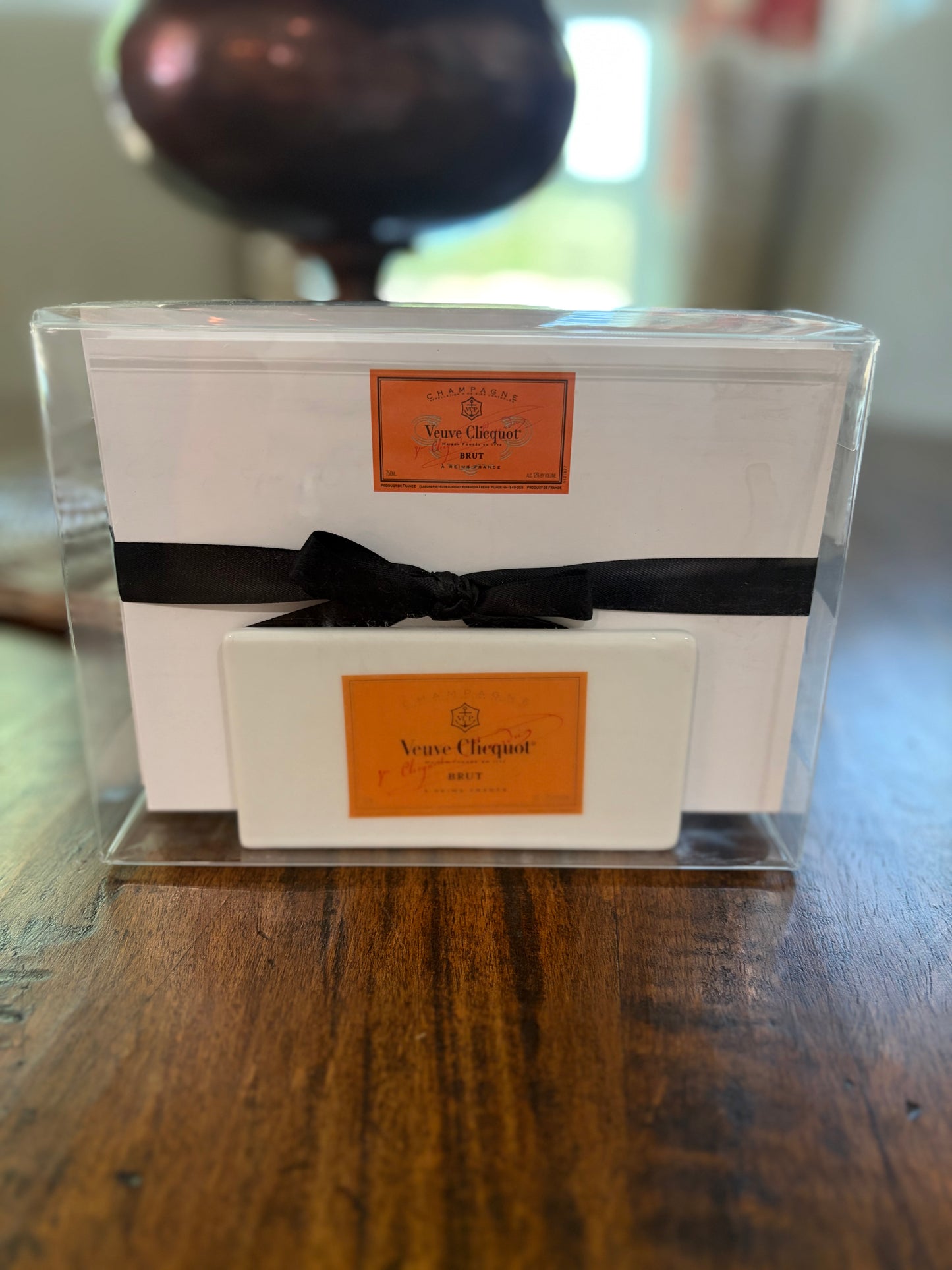 set of note cards and envelopes in an porcelain stand that has iconic champagne logo