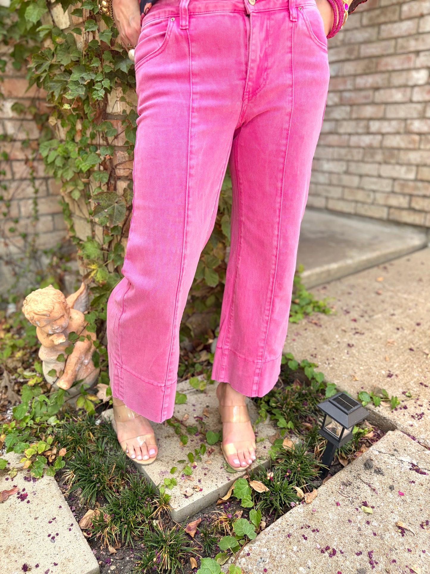 a cropped hot pink jean in mid rise with exposed seam and wide leg