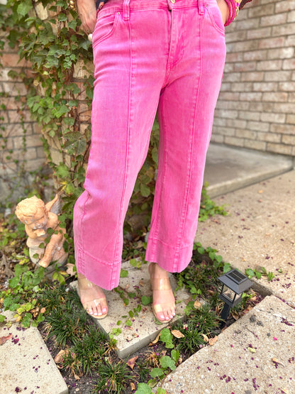 a cropped hot pink jean in mid rise with exposed seam and wide leg