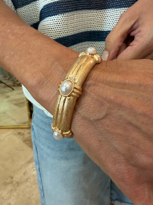 Gold, bangle bracelet  that is water resistant with pearl accents