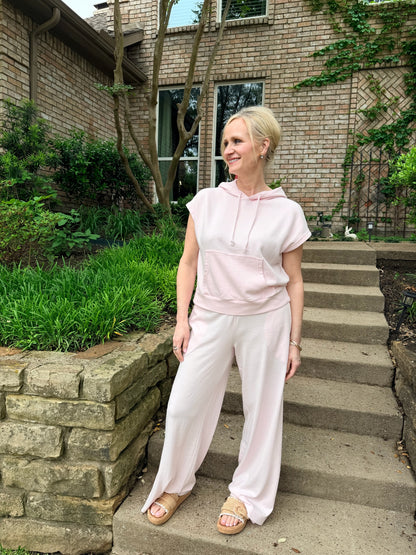 woman in pink pull on pant, elastic waist, pockets. paired with pink pullover hoodie with draw string