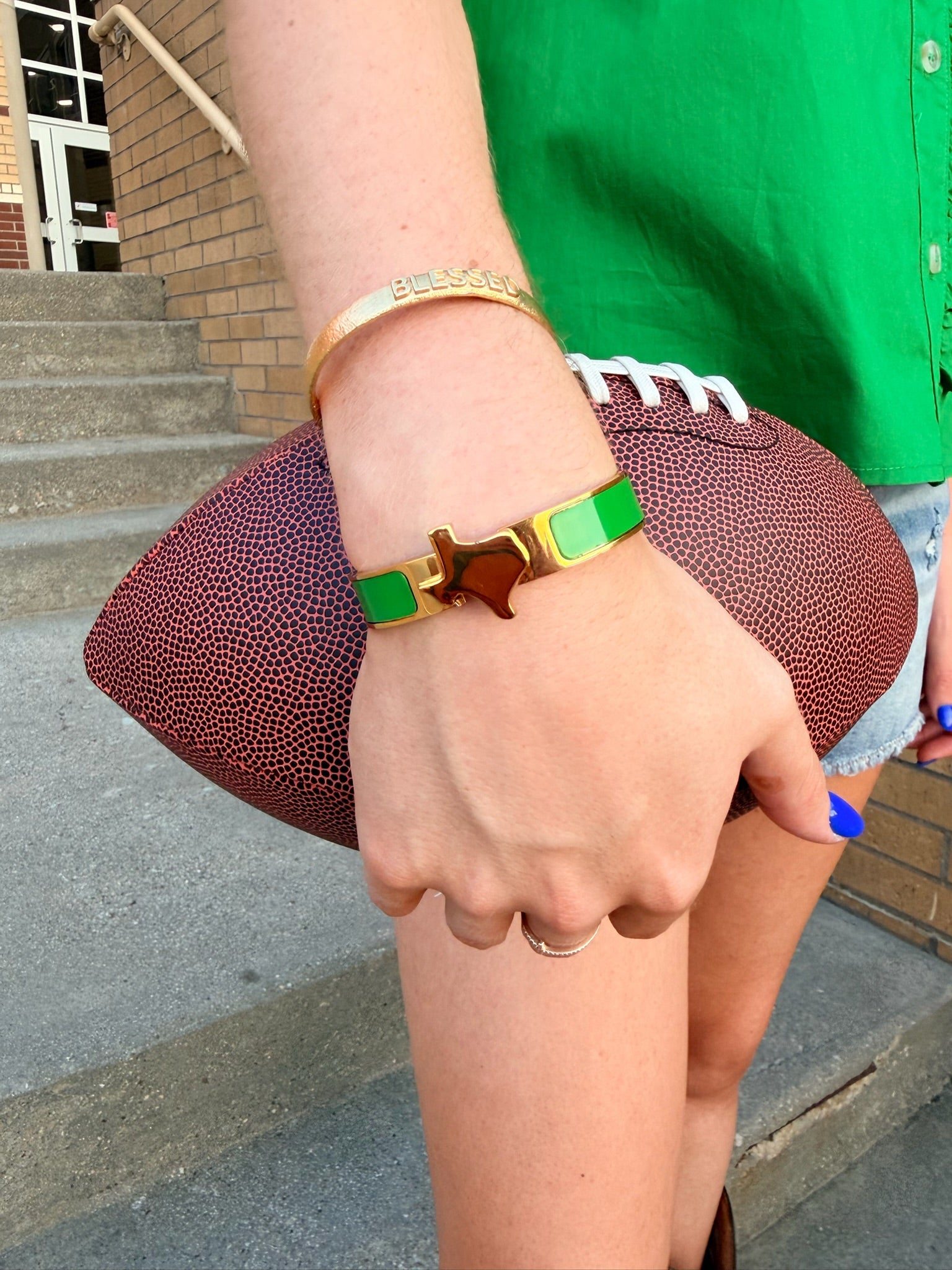 green and gold bangle bracelet with gold center in shape of texas