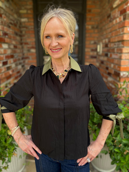 black button blouse with detachable olive green collar with olive green accent on the cuff tied in bow