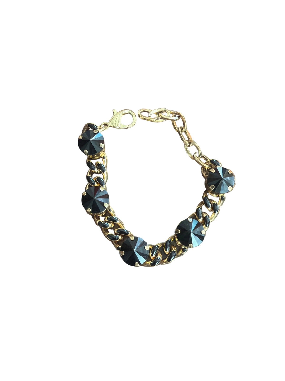 gold link bracelet with black enamel details on link with 5 black stones that sit on link in gold prongs