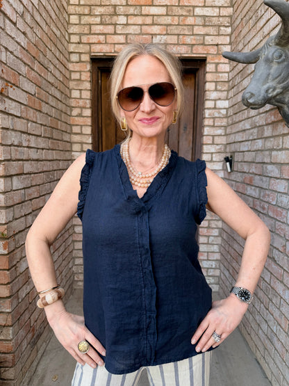 woman in a sleeveless Italian top, v neck, ruffled blouse. Navy blue