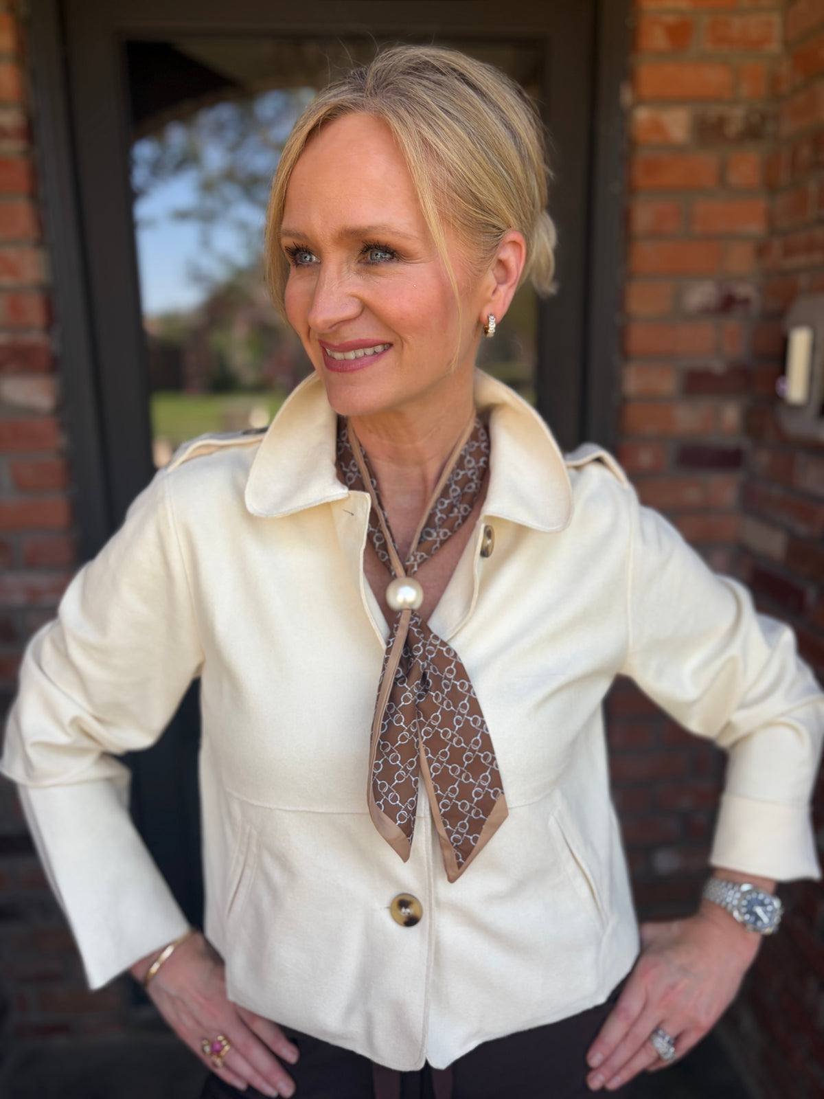 a light weight, suede feelling crop cream jacket. long sleeves with tortoise button down and epaulettes on shoulder