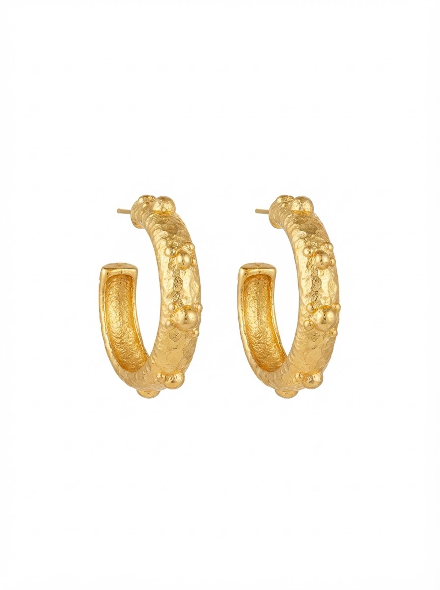 A pair of textured brush gold hoop earrings with a hammered, organic surface finish, shown against a plain white background.