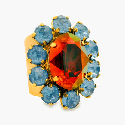 Tova edith ring in chocolate that is an oval chocolate colored swarovski stone with smaller round blue swarvoski stones on gold, adjustable band