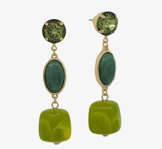 A pair of gold-tone drop earrings featuring round green top stones, oval green center stones, and large lime-green square pendant beads, shown against a plain light gray background.