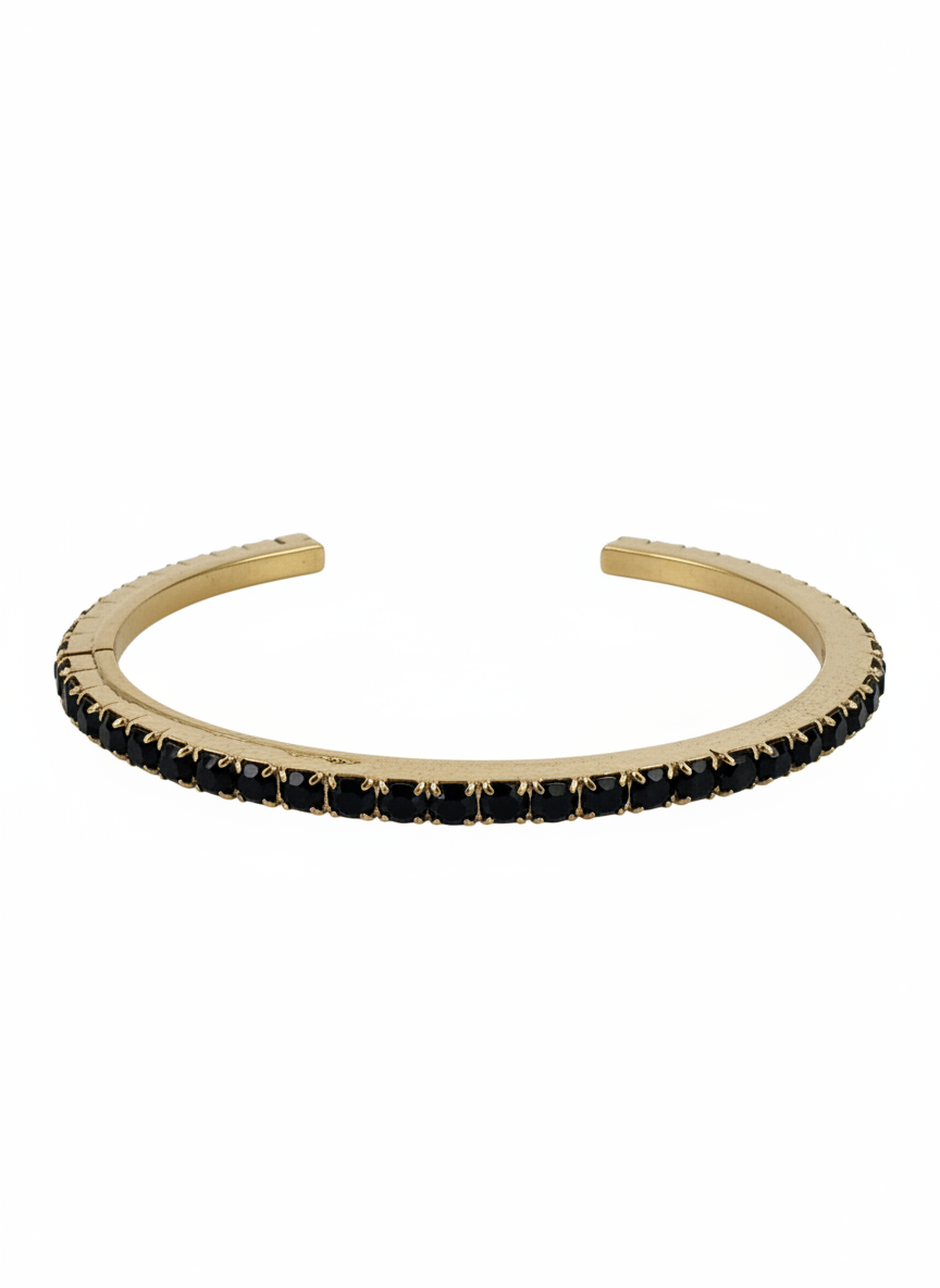 A gold-toned Tova open cuff bangle bracelet embellished with a row of small black rectangular Swarovski crystals