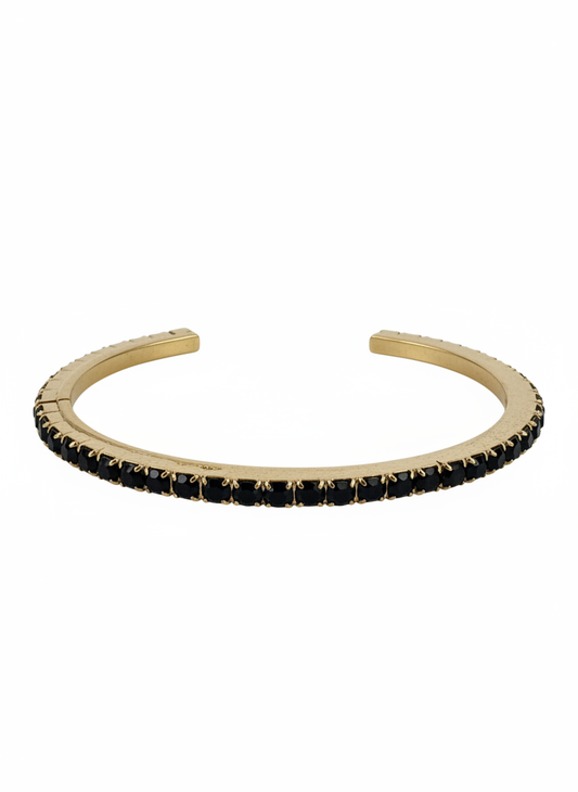 A gold-toned Tova open cuff bangle bracelet embellished with a row of small black rectangular Swarovski crystals