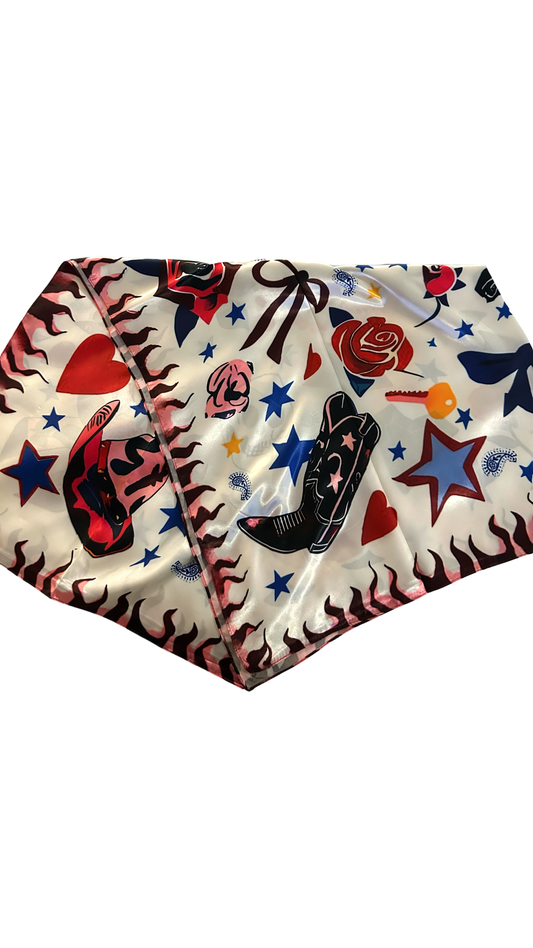 silk like, white scarf with western flare. has stars, black cowboy boots, red roses and bows. 