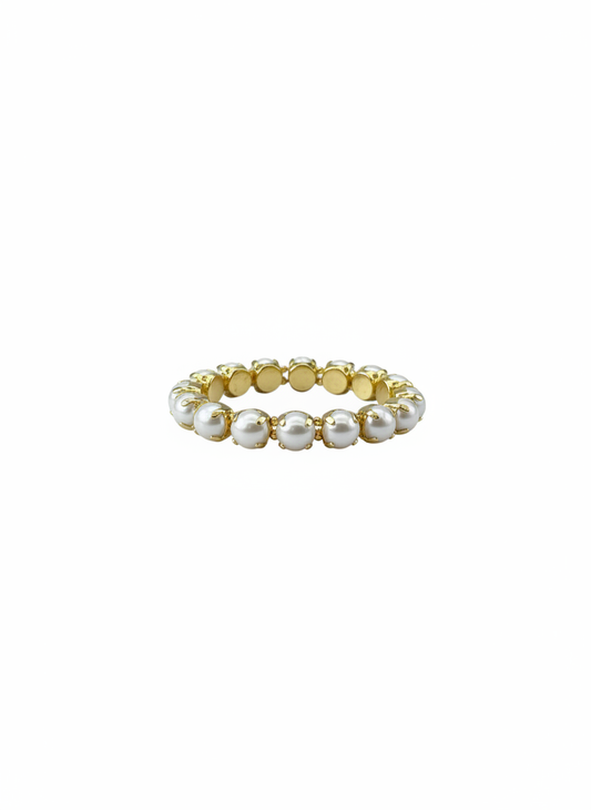 A delicate gold plated water resistant stretch bracelet  featuring a row of small, lustrous white  pearls, shown against a solid white background.