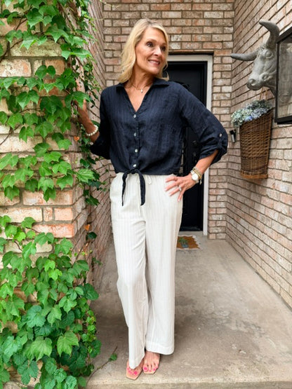 woman in blue linen top with a white  pant