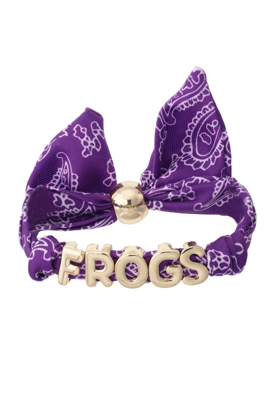 Purple bandana bracelet with gold accents and 'FROGS' spelled out. 