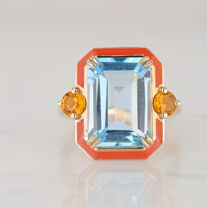 sized ring set in gold plated band. Orange color outer edge and citrine stones and blue stone in the middle